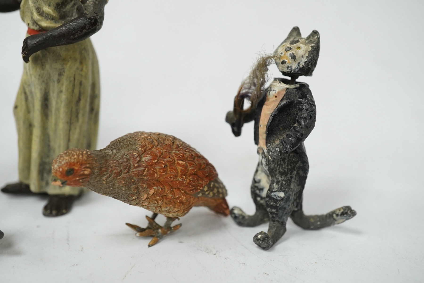 A collection of cold-painted figures and a tinplate and clockwork hare, largest 10cm high. Condition - fair